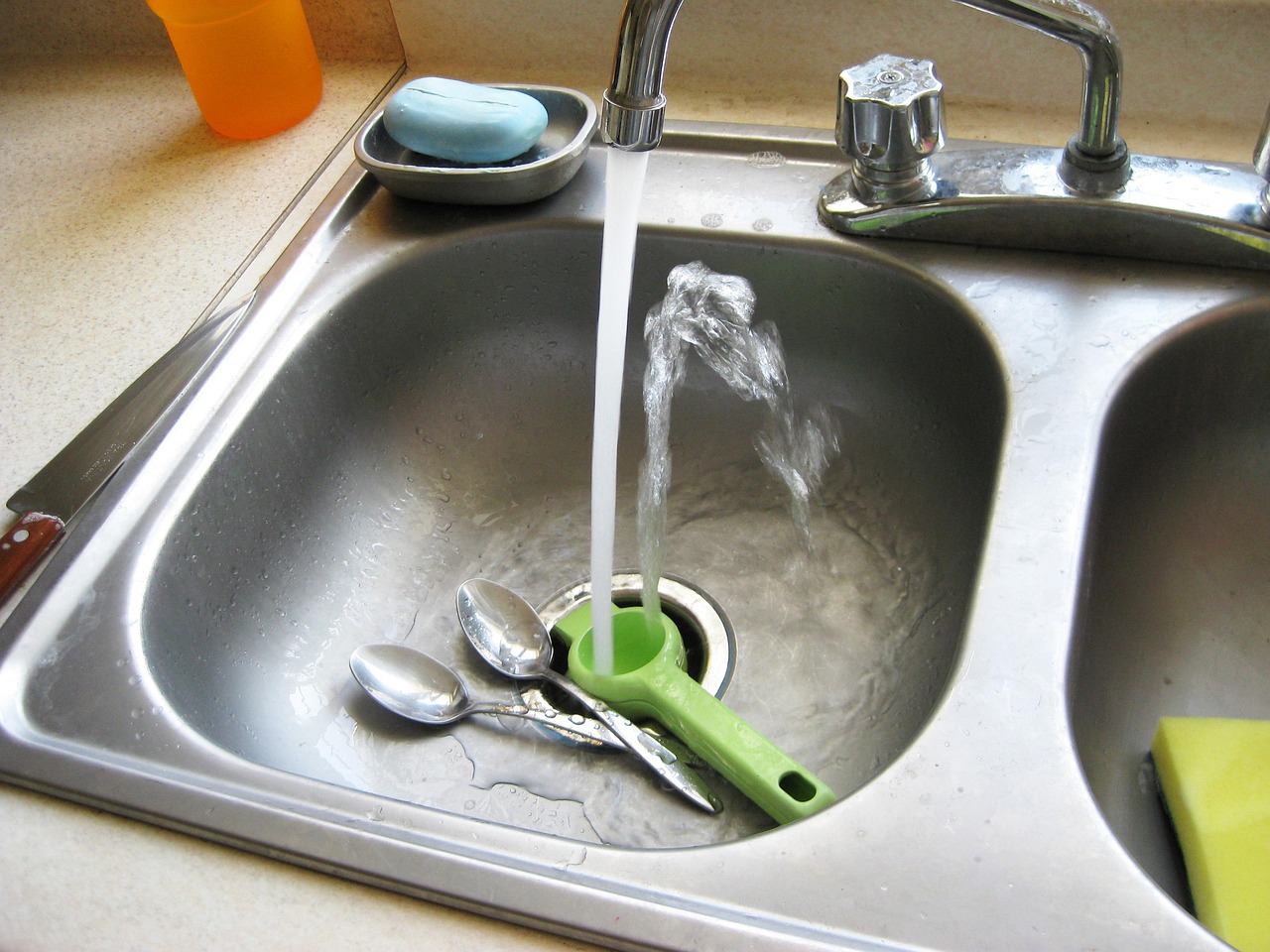 Quartz countertop surface around a stainless undermount kitchen sink